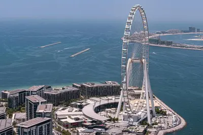 an aerial view of a ferris wheel near the water at SkyHigh Stay, Panoramic Sea Views & Beach Access in Dubai