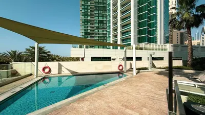 a swimming pool in a city with tall buildings at SkyHigh Stay, Panoramic Sea Views & Beach Access in Dubai