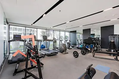 a gym with several treadmills and exercise bikes at Nobles Tower tiger one skyline view in Dubai