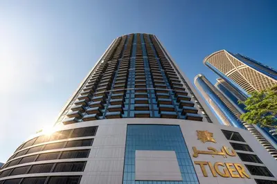 a tall building with a sign on the side of it at Nobles Tower tiger one skyline view in Dubai