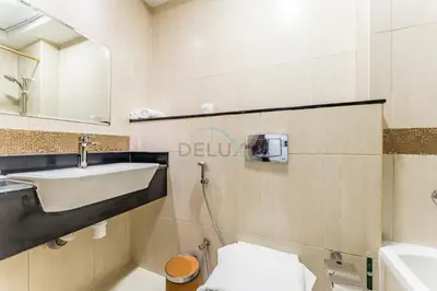 a bathroom with a sink and a toilet at Studio with Balcony Overlooking the Community, Walking Distance from the Park, Hanover Square HSS, Jumeirah Village Circle by Deluxe Holiday Homes in Dubai
