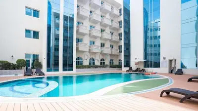 a swimming pool in the courtyard of a building at Studio with Balcony Overlooking the Community, Walking Distance from the Park, Hanover Square HSS, Jumeirah Village Circle by Deluxe Holiday Homes in Dubai