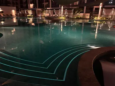 a swimming pool in a building at night at Dubai dream in Dubai