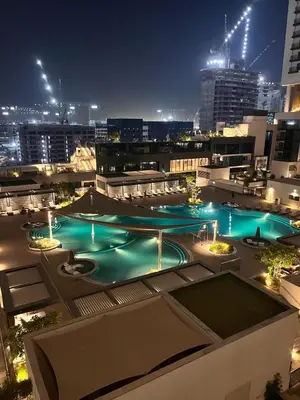 a view of a pool on a building at night at Dubai dream in Dubai