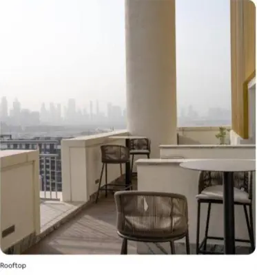 a room with chairs and tables and a view of a city at Dubai dream in Dubai