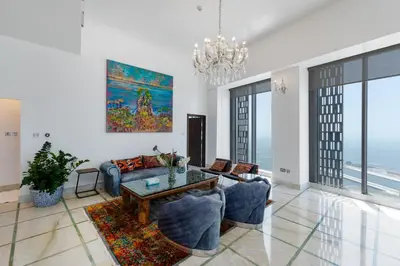 a living room with a couch and a table at Cayan Tower Dubai Marina - Mint Stay in Dubai