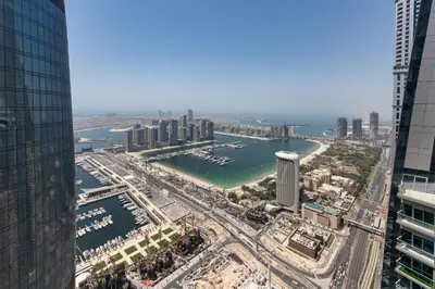 an aerial view of a city with a river and buildings at Cayan Tower Dubai Marina - Mint Stay in Dubai