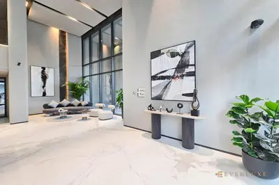 a living room with white walls and a potted plant at Contemporary Studio Terrace Luxe & Secure Stay in Dubai