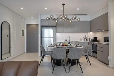a kitchen and dining room with a table and chairs at Luxury2BR Sea View Hot Tub Walk to Burj Dubai Mall in Dubai