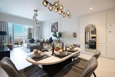 a living room with a table and chairs at Luxury2BR Sea View Hot Tub Walk to Burj Dubai Mall in Dubai