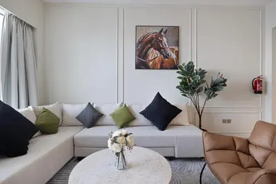 a living room with a couch and a table at Luxury2BR Sea View Hot Tub Walk to Burj Dubai Mall in Dubai