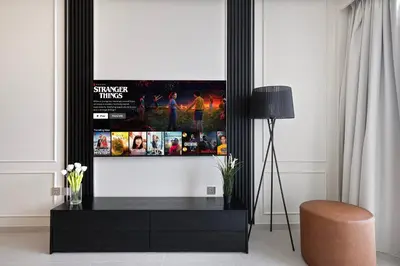 a living room with a flat screen tv on a wall at Luxury2BR Sea View Hot Tub Walk to Burj Dubai Mall in Dubai