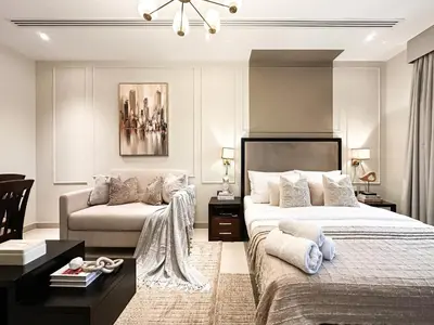 a bedroom with a bed and a couch at Modern Studio Downtown Dubai Luxury & Convenience in Dubai