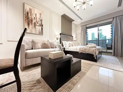 a living room with a couch and a bed at Modern Studio Downtown Dubai Luxury & Convenience in Dubai
