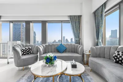a living room with couches and a table at Stunning 3BR Burj Fountain view & Dubai Mall in Dubai