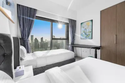 a hotel room with two beds and a window at Stunning 3BR Burj Fountain view & Dubai Mall in Dubai