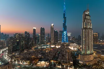 a view of a city skyline at night at Stunning 3BR Burj Fountain view & Dubai Mall in Dubai