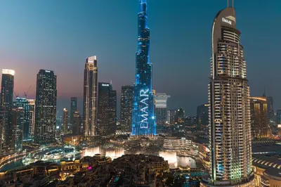 a city skyline at night with a tall building at Stunning 3BR Burj Fountain view & Dubai Mall in Dubai
