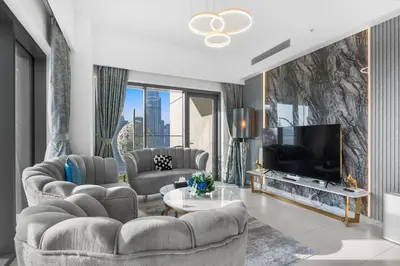 a living room with couches and a large television at Stunning 3BR Burj Fountain view & Dubai Mall in Dubai
