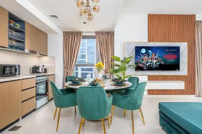a kitchen and dining room with a table and chairs at Stylish 2BR with Boulevard View & 5 min from Dubai Mall in Dubai