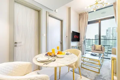 a living room with a table with fruit on it at Modern 1BR in Business Bay - Balcony with Skyline Views in Dubai