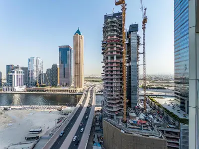 a tall building under construction in a city at Modern 1BR in Business Bay - Balcony with Skyline Views in Dubai