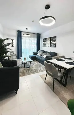 a living room with a couch and a table at C Infinity Holiday Homes in Dubai Marina in Dubai