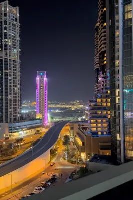 a view of a city at night with tall buildings at C Infinity Holiday Homes in Dubai Marina in Dubai