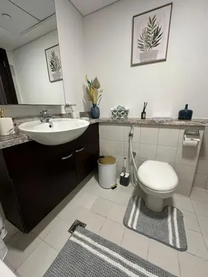 a bathroom with a sink and a toilet at C Infinity Holiday Homes in Dubai Marina in Dubai