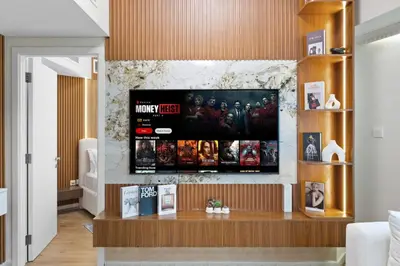 a living room with a television on a wall at Elegant Haven and Spacious 2BR in Lake Terrace in Dubai