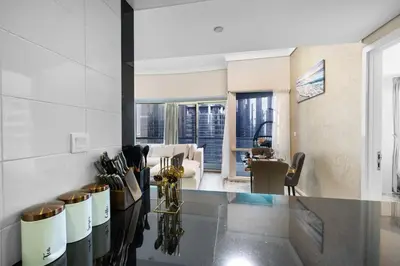 a kitchen with a counter and a living room at Elegant Haven and Spacious 2BR in Lake Terrace in Dubai