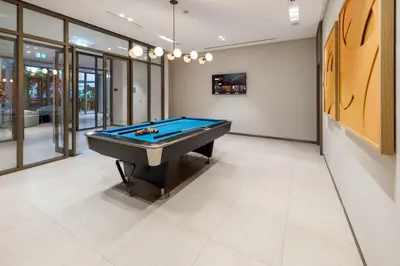 a billiard room with a blue pool table at Luxury Grande 2BR Near DubaiMall in Dubai