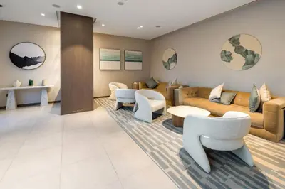 a living room with couches and tables and chairs at Luxury Grande 2BR Near DubaiMall in Dubai