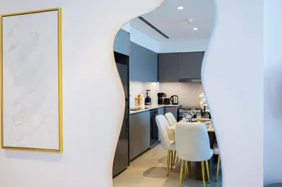 a kitchen and dining room with a framed map on the wall at Luxury 2BR Apartment in Downtown Dubai in Dubai
