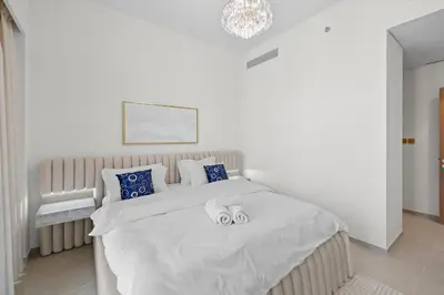 a bedroom with a bed with two towels on it at Luxury 2BR Apartment in Downtown Dubai in Dubai