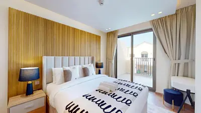 a bedroom with a large bed and a large window at Jumeirah Golf Estate - Elegant Three Bed Villa in Dubai