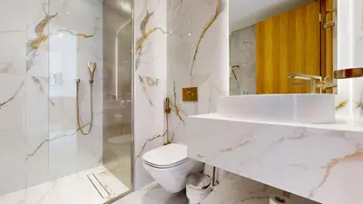 a white bathroom with a sink and a toilet at Jumeirah Golf Estate - Elegant Three Bed Villa in Dubai
