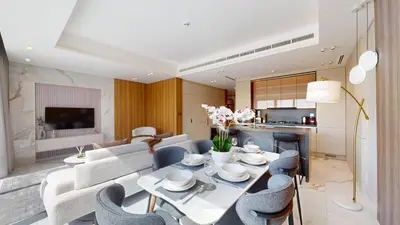 a dining room and living room with a table and chairs at Jumeirah Golf Estate - Elegant Three Bed Villa in Dubai