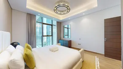 a bedroom with a white bed and a large window at Vacationer I Vista 2 Bedroom I Business Bay I Free Parking, Pool, Gym & Wi-Fi in Dubai