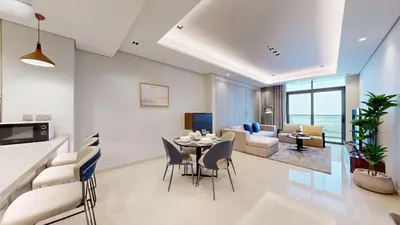 a dining room and living room with a table and chairs at Vacationer I Vista 2 Bedroom I Business Bay I Free Parking, Pool, Gym & Wi-Fi in Dubai