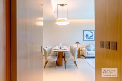 a dining room with a table and chairs at Luxury 3BR Apartment with Burj Khalifa Views - Address Opera in Dubai