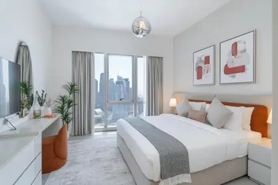 a white bedroom with a large bed and a large window at Lux 3 BR & Maidroom Burj & Fountain View 1Gbps WIFI in Dubai