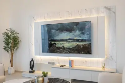 a living room with a painting on the wall at Lux 3 BR & Maidroom Burj & Fountain View 1Gbps WIFI in Dubai