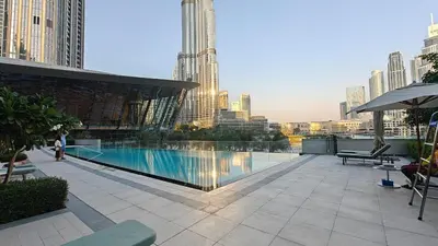a swimming pool on top of a building with a city at Lux 3 BR & Maidroom Burj & Fountain View 1Gbps WIFI in Dubai