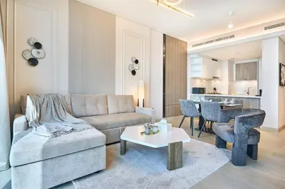 a living room with a couch and a table at STAY BY LATINEM Luxury 1BR Holiday Home OPA2401 near Burj Khalifa in Dubai