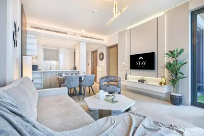 a living room with a couch and a table at STAY BY LATINEM Luxury 1BR Holiday Home OPA2401 near Burj Khalifa in Dubai