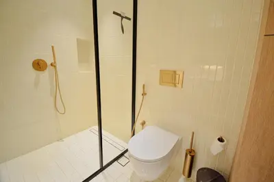 a bathroom with a shower with a toilet and a shower at Modern Studio at Upside Living, Business Bay with Burj Khalifa View in Dubai