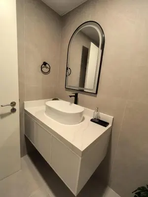 a bathroom with a white sink and a mirror at Air Homes - Stylish Urban Living in a Modern 1BR in Dubai
