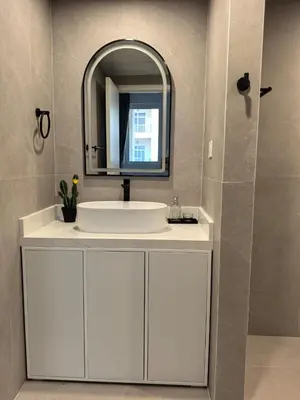 a bathroom with a white sink and a mirror at Air Homes - Stylish Urban Living in a Modern 1BR in Dubai