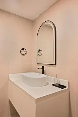 a bathroom with a white sink and a mirror at Air Homes - Stylish Urban Living in a Modern 1BR in Dubai